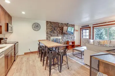 a kitchen and living room with a table and chairs at Dine, Shop and Shuttle to Resort Winter Park Haven! in Winter Park