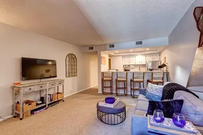 a living room with a blue couch and a kitchen at Mountainside Retreat - Sleeps 4 in Frisco