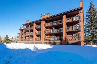 a building with a lot of snow in front of it at Mountainside Retreat - Sleeps 4 in Frisco