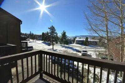 a view from the balcony of a house in the snow at Our Mountain Blessings Condominium Town Home - peaceful, cozy, and family friendly mountain getaway! The most ideally located unit in Meadow Ridge Resort, in Fraser