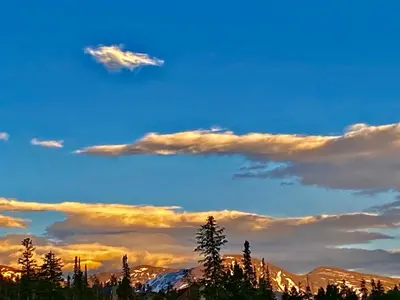a blue sky with clouds and trees and mountains at Our Mountain Blessings Condominium Town Home - peaceful, cozy, and family friendly mountain getaway! The most ideally located unit in Meadow Ridge Resort, in Fraser
