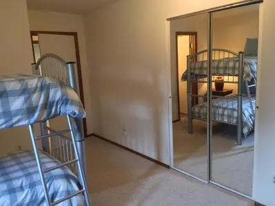 a room with two bunk beds and a mirror at Our Mountain Blessings Condominium Town Home - peaceful, cozy, and family friendly mountain getaway! The most ideally located unit in Meadow Ridge Resort, in Fraser