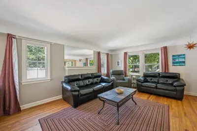 a living room with leather furniture and a table at Charming Home Near UNC & DT Greeley home in Greeley