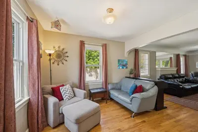 a living room with two chairs and a couch at Charming Home Near UNC & DT Greeley home in Greeley