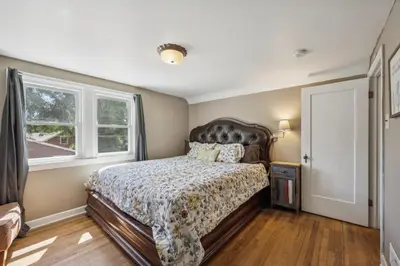 a bedroom with a large bed and a window at Charming Home Near UNC & DT Greeley home in Greeley