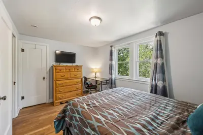a bedroom with a bed and a dresser and a window at Charming Home Near UNC & DT Greeley home in Greeley