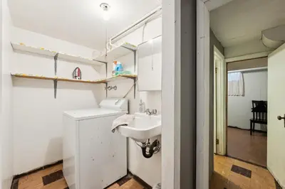 a white bathroom with a sink and a mirror at Charming Home Near UNC & DT Greeley home in Greeley