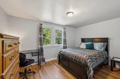 a bedroom with a bed and a window at Charming Home Near UNC & DT Greeley home in Greeley