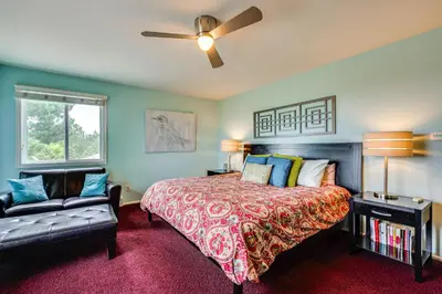 a bedroom with a bed and a couch at Mtn-View Home with Pickleball Court in Louisville! in Louisville