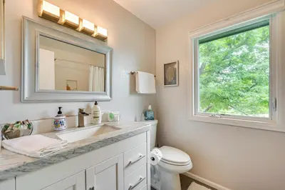 a bathroom with a sink and a mirror and a toilet at Mtn-View Home with Pickleball Court in Louisville! in Louisville