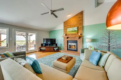 a living room with a couch and a fireplace at Mtn-View Home with Pickleball Court in Louisville! in Louisville