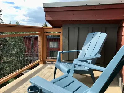 a blue rocking chair sitting on a porch at Summit Vista Villa- Hike, Ski, Bike! in Fraser