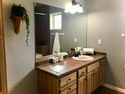 a bathroom with a sink and a mirror at Summit Vista Villa- Hike, Ski, Bike! in Fraser