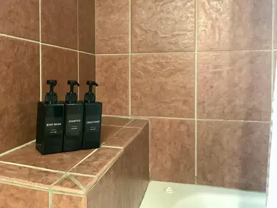 two bottles of soap sitting on a counter in a bathroom at Summit Vista Villa- Hike, Ski, Bike! in Fraser