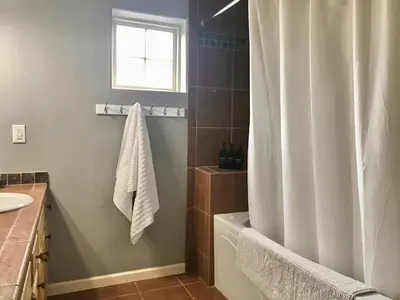 a bathroom with a shower curtain and a sink at Summit Vista Villa- Hike, Ski, Bike! in Fraser