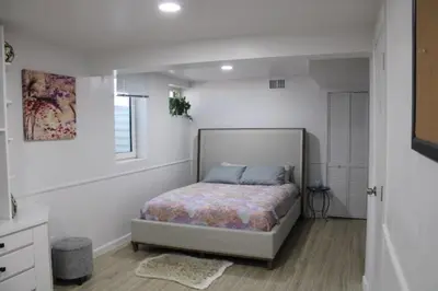 a bedroom with a bed in a white room at Large Guest Suite with Private-Cozy-Central 1-BD 1-BT & Kitchen in Greenwood Village