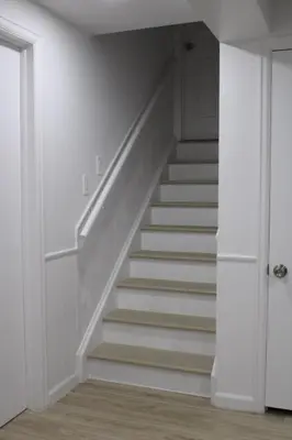 a staircase in a room with white walls and white stairs at Large Guest Suite with Private-Cozy-Central 1-BD 1-BT & Kitchen in Greenwood Village
