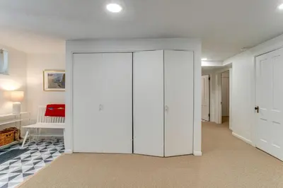 a white closet in a room with a door at Walkable Apt with Off-Street Parking in Cheesman! in Denver