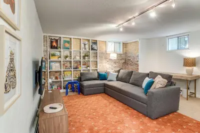 a living room with a couch and a table at Walkable Apt with Off-Street Parking in Cheesman! in Denver