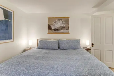 a bedroom with a blue bed with two lamps at Walkable Apt with Off-Street Parking in Cheesman! in Denver