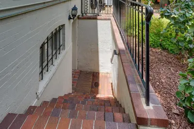 a staircase leading up to a house with a fence at Walkable Apt with Off-Street Parking in Cheesman! in Denver