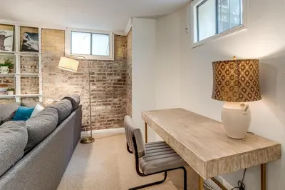 a living room with a couch and a table at Walkable Apt with Off-Street Parking in Cheesman! in Denver