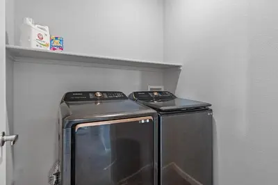 a microwave in a kitchen with a shelf at 10 min to DT, Luxe 4BR w Movie Theater, Game Room in Commerce City