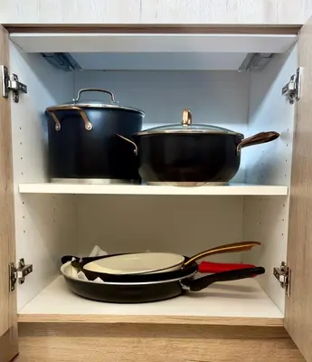 a shelf with two pots and pans in a cabinet at Luxury modern, Central Ski, No stairs, EV! in Silverthorne