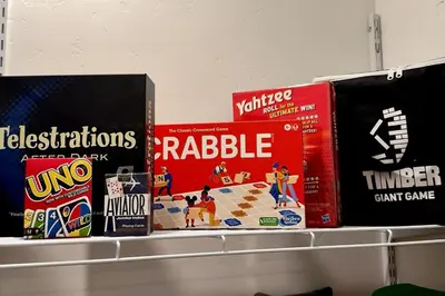 a shelf with some board games on it at Luxury modern, Central Ski, No stairs, EV! in Silverthorne