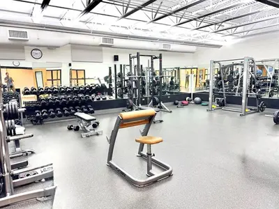 a gym with lots of equipment and a chair in it at Luxury modern, Central Ski, No stairs, EV! in Silverthorne