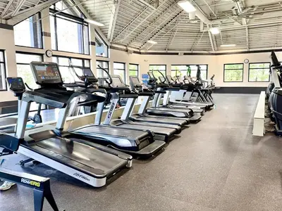 a gym with a row of treadmills at Luxury modern, Central Ski, No stairs, EV! in Silverthorne