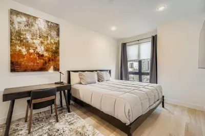 a bedroom with a bed and a desk and a painting at River West 822 in Silverthorne