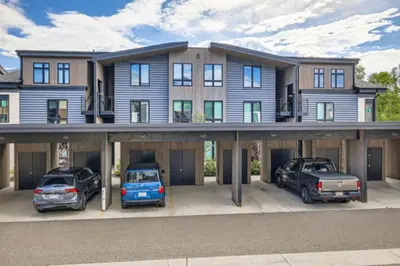 a large house with cars parked in a parking lot at River West 822 in Silverthorne