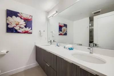 a bathroom with two sinks and a large mirror at River West 822 in Silverthorne