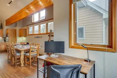 a kitchen and dining room with a table with a television at Patio with Peak 1 Mtn View Main Street Frisco Condo in Frisco