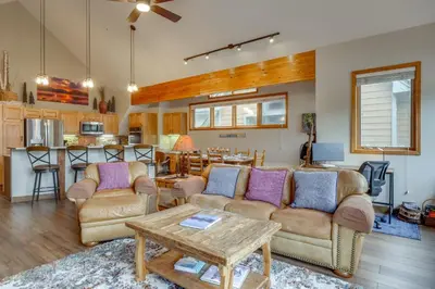 a living room with couches and a table and a kitchen at Patio with Peak 1 Mtn View Main Street Frisco Condo in Frisco