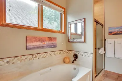 a bathroom with a tub and a window at Patio with Peak 1 Mtn View Main Street Frisco Condo in Frisco