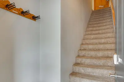 a staircase in a house with a stair railing at Patio with Peak 1 Mtn View Main Street Frisco Condo in Frisco