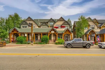a car parked in front of a large house at Patio with Peak 1 Mtn View Main Street Frisco Condo in Frisco
