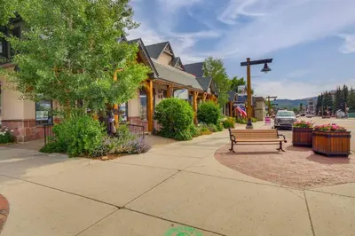 a bench sitting on a sidewalk in a town at Patio with Peak 1 Mtn View Main Street Frisco Condo in Frisco