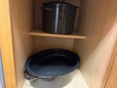 a black bucket on a shelf in a pantry at Condo 2BR on Winter Park Ski Bus Route for Christmas in Fraser