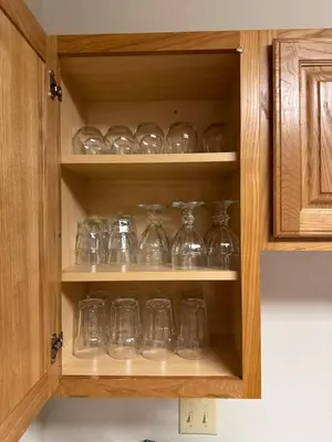 a cupboard filled with lots of glass dishes at Condo 2BR on Winter Park Ski Bus Route for Christmas in Fraser