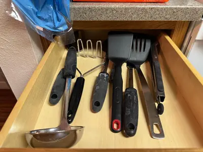 a drawer filled with knives and utensils on a counter at Condo 2BR on Winter Park Ski Bus Route for Christmas in Fraser