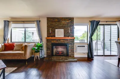 a living room with a fireplace and a couch at 2 Mi to CU Boulder Mtn-View Condo with Pool Access in Boulder