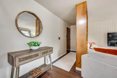 a room with a table and a mirror on the wall at 2 Mi to CU Boulder Mtn-View Condo with Pool Access in Boulder