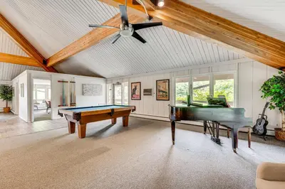a living room with a pool table and a piano at 2 Mi to CU Boulder Mtn-View Condo with Pool Access in Boulder