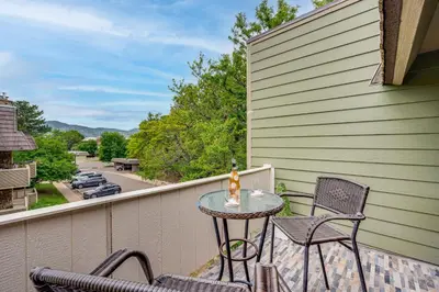 a patio with a table and chairs on a balcony at 2 Mi to CU Boulder Mtn-View Condo with Pool Access in Boulder