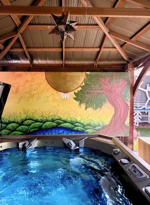 a hot tub in a room with a painting on the wall at Artful Stay, Downtown, Spacious, LED Art, Hot Tub in Denver