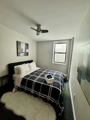 a bedroom with a bed and a ceiling fan at Artful Stay, Downtown, Spacious, LED Art, Hot Tub in Denver