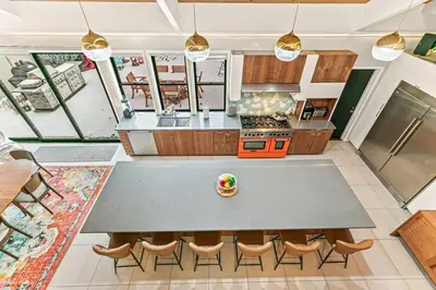 a large kitchen with a table and chairs at Artful Stay, Downtown, Spacious, LED Art, Hot Tub in Denver